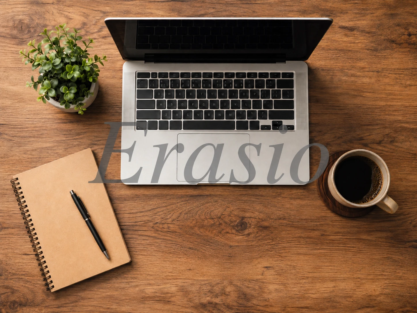 Wooden desk workspace with a large semi-transparent Erasio stock photo watermark